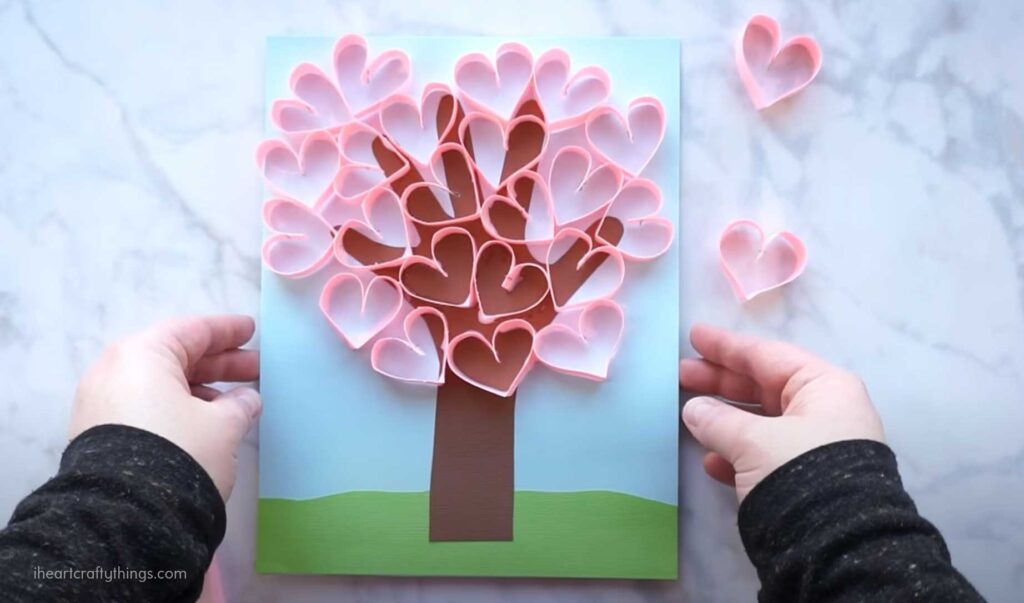 tree with handprint as the trunk and paper heart leaves