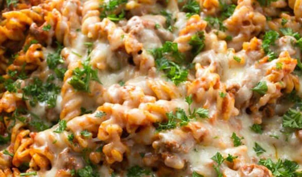 A close-up of skillet cheesy beef ziti is pictured. It is one of the Italian dishes on my list of easy, kid-friendly dinner recipes.