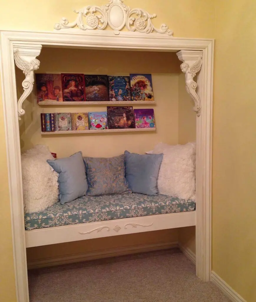 reading nook tucked away in a closet, adorned with decorative molding.