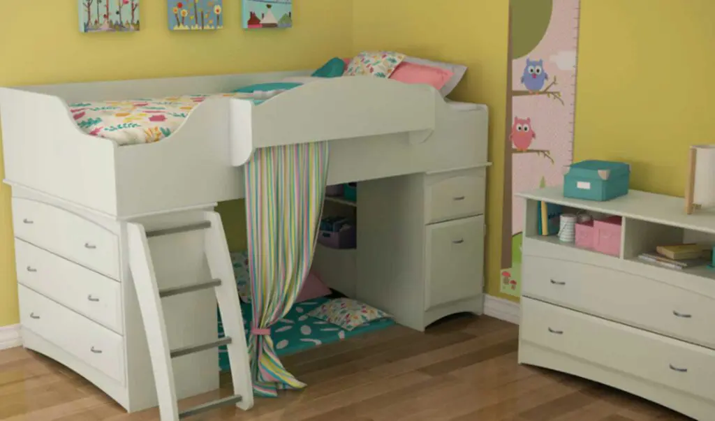 a white loft bed with a pastel striped curtain partially covering the reading nook underneath, which has a turquoise and white-patterned floor mat and pastel print throw pillows.